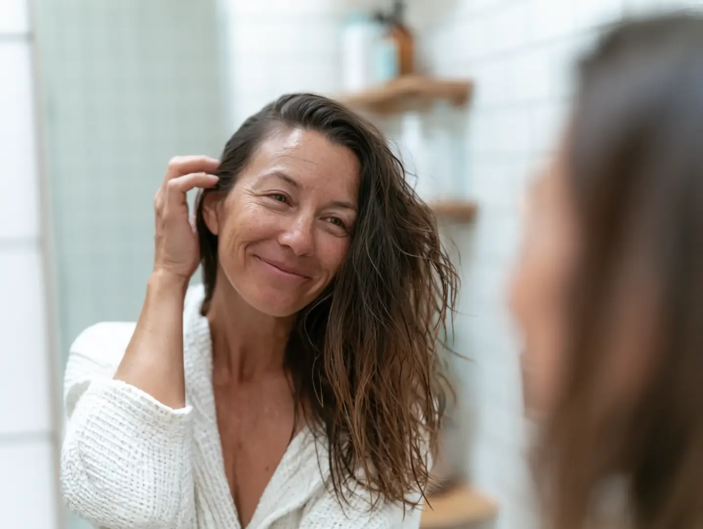 Woman gently running her fingers through her hair