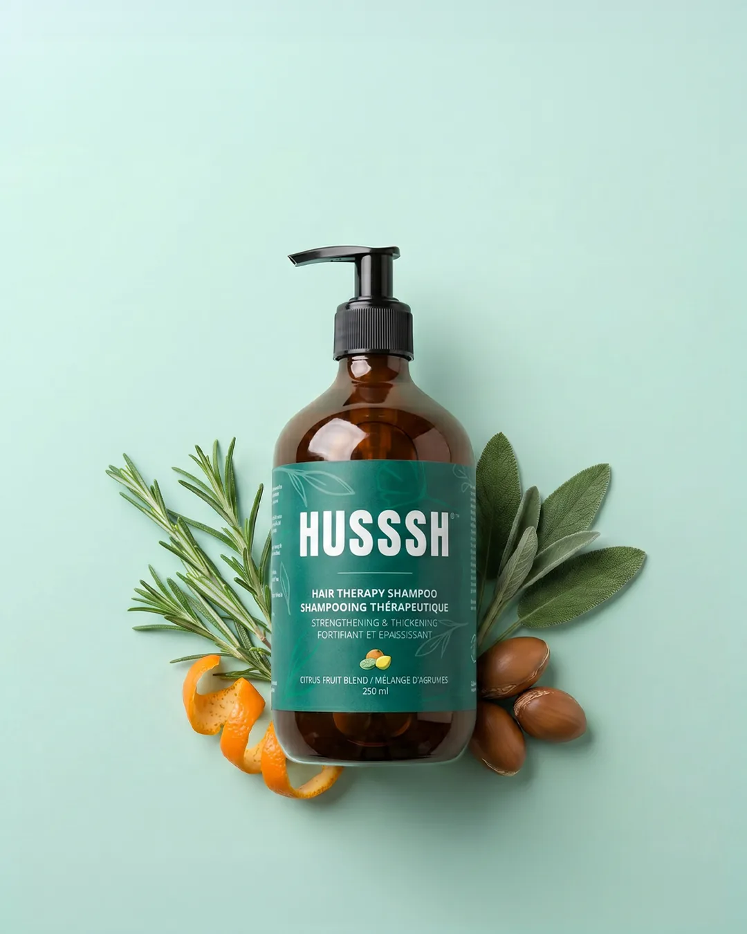 HUSSSH Hair Therapy Shampoo from above, with rosemary, sage, orange peel and argan nuts